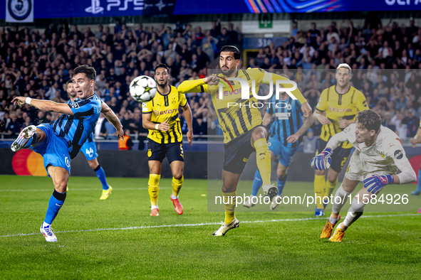 Club Brugge midfielder Hugo Vetlesen, Borussia Dortmund defender Emre Can, and Borussia Dortmund goalkeeper Gregor Kobel during the match be...