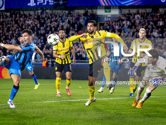 Club Brugge midfielder Hugo Vetlesen, Borussia Dortmund defender Emre Can, and Borussia Dortmund goalkeeper Gregor Kobel during the match be...