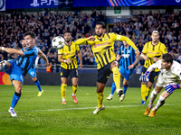 Club Brugge midfielder Hugo Vetlesen, Borussia Dortmund defender Emre Can, and Borussia Dortmund goalkeeper Gregor Kobel during the match be...