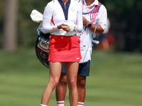 GAINESVILLE, VIRGINIA - SEPTEMBER 15: Alison Lee of the United States and her caddie look down the 13th fairway during the final round of th...