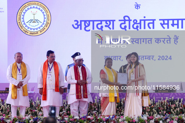 President Droupadi Murmu presents certificates to students during the 18th Convocation ceremony at Malviya National Institute of Technology...