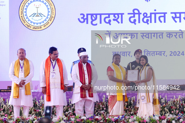 President Droupadi Murmu presents certificates to students during the 18th Convocation ceremony at Malviya National Institute of Technology...