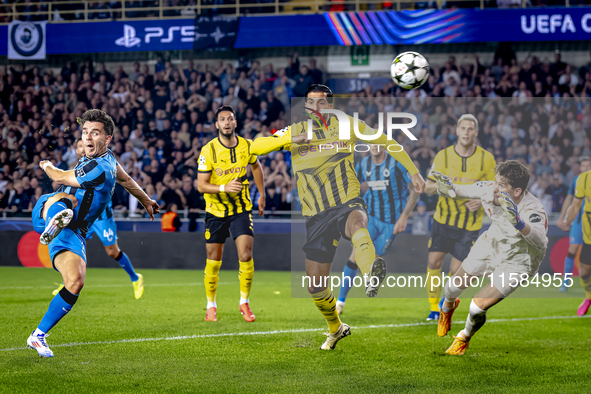 Club Brugge midfielder Hugo Vetlesen, Borussia Dortmund defender Emre Can, and Borussia Dortmund goalkeeper Gregor Kobel during the match be...