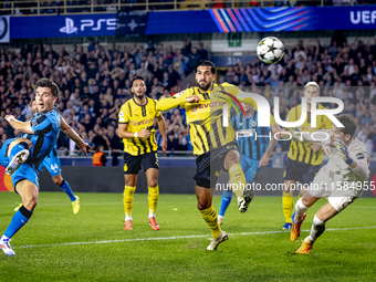 Club Brugge midfielder Hugo Vetlesen, Borussia Dortmund defender Emre Can, and Borussia Dortmund goalkeeper Gregor Kobel during the match be...