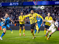 Club Brugge midfielder Hugo Vetlesen, Borussia Dortmund defender Emre Can, and Borussia Dortmund goalkeeper Gregor Kobel during the match be...