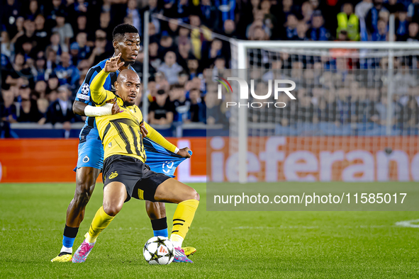 Borussia Dortmund forward Donyell Malen and Club Brugge midfielder Raphael Onyedika during the match between Club Brugge and Borussia Dortmu...