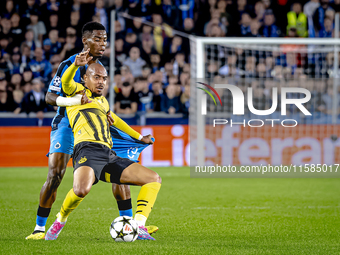 Borussia Dortmund forward Donyell Malen and Club Brugge midfielder Raphael Onyedika during the match between Club Brugge and Borussia Dortmu...