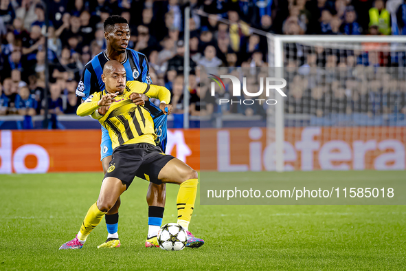 Borussia Dortmund forward Donyell Malen and Club Brugge midfielder Raphael Onyedika during the match between Club Brugge and Borussia Dortmu...