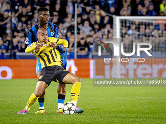 Borussia Dortmund forward Donyell Malen and Club Brugge midfielder Raphael Onyedika during the match between Club Brugge and Borussia Dortmu...