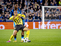 Borussia Dortmund forward Donyell Malen and Club Brugge midfielder Raphael Onyedika during the match between Club Brugge and Borussia Dortmu...