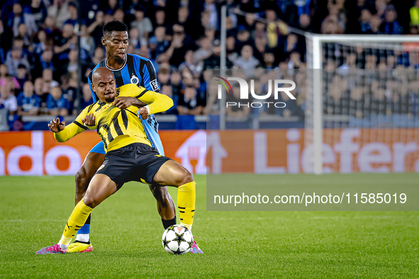 Borussia Dortmund forward Donyell Malen and Club Brugge midfielder Raphael Onyedika during the match between Club Brugge and Borussia Dortmu...