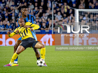 Borussia Dortmund forward Donyell Malen and Club Brugge midfielder Raphael Onyedika during the match between Club Brugge and Borussia Dortmu...