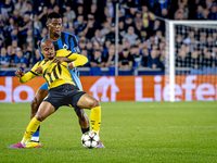 Borussia Dortmund forward Donyell Malen and Club Brugge midfielder Raphael Onyedika during the match between Club Brugge and Borussia Dortmu...