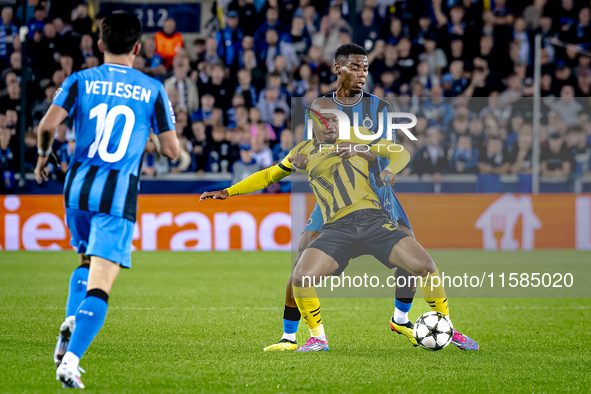 Borussia Dortmund forward Donyell Malen and Club Brugge midfielder Raphael Onyedika during the match between Club Brugge and Borussia Dortmu...