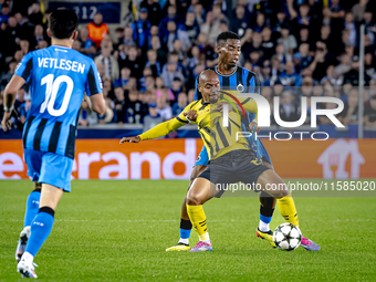 Borussia Dortmund forward Donyell Malen and Club Brugge midfielder Raphael Onyedika during the match between Club Brugge and Borussia Dortmu...