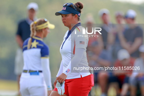 GAINESVILLE, VIRGINIA - SEPTEMBER 15: Megan Khang of the United States walks on the 13th green with Emily Kristine Pedersen of Team Europe i...