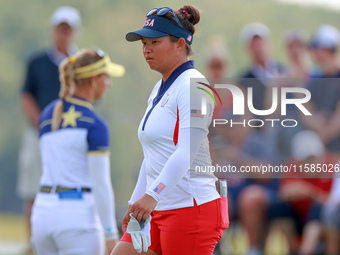 GAINESVILLE, VIRGINIA - SEPTEMBER 15: Megan Khang of the United States walks on the 13th green with Emily Kristine Pedersen of Team Europe i...