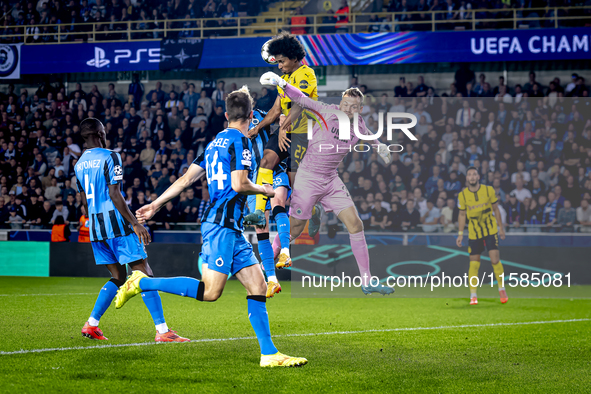 Borussia Dortmund forward Karim Adeyemi, Club Brugge goalkeeper Simon Mignolet, and Club Brugge defender Joaquin Seys during the match betwe...