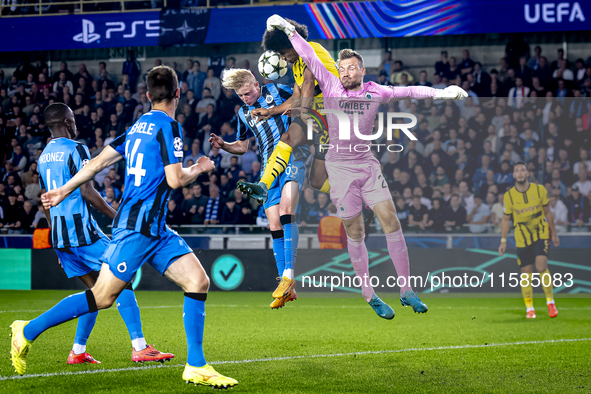 Borussia Dortmund forward Karim Adeyemi, Club Brugge goalkeeper Simon Mignolet, and Club Brugge defender Joaquin Seys during the match betwe...