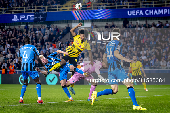 Borussia Dortmund forward Karim Adeyemi, Club Brugge goalkeeper Simon Mignolet, and Club Brugge defender Joaquin Seys during the match betwe...