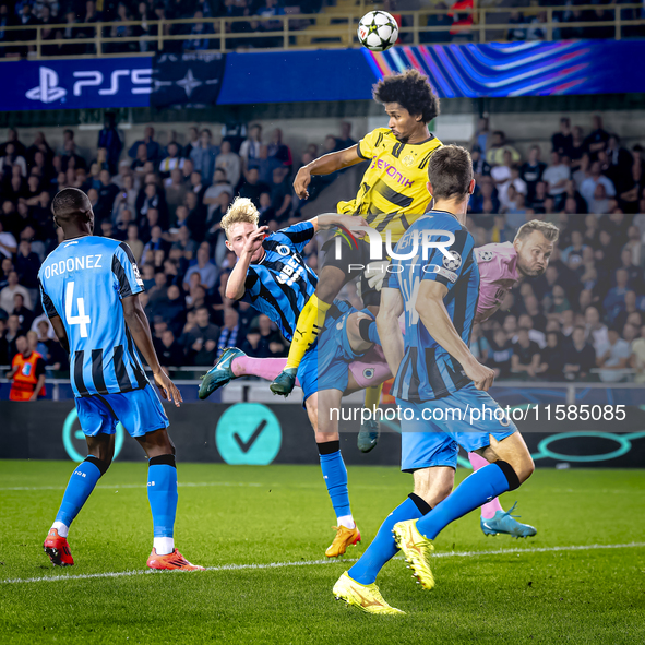 Borussia Dortmund forward Karim Adeyemi, Club Brugge goalkeeper Simon Mignolet, and Club Brugge defender Joaquin Seys during the match betwe...