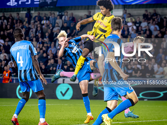 Borussia Dortmund forward Karim Adeyemi, Club Brugge goalkeeper Simon Mignolet, and Club Brugge defender Joaquin Seys during the match betwe...