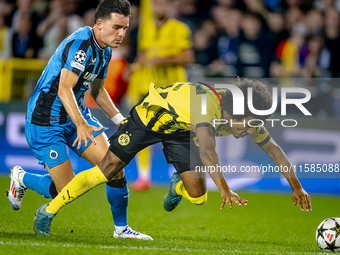 Club Brugge midfielder Hugo Vetlesen and Borussia Dortmund forward Karim Adeyemi during the match between Club Brugge and Borussia Dortmund...