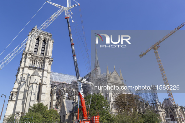 An exterior view of Notre Dame and construction cranes while the reconstruction process takes place in Paris, France, on September 15, 2024....