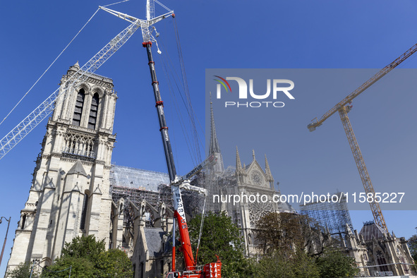 An exterior view of Notre Dame and construction cranes while the reconstruction process takes place in Paris, France, on September 15, 2024....