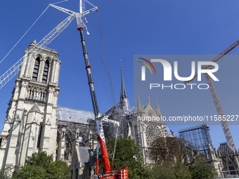 An exterior view of Notre Dame and construction cranes while the reconstruction process takes place in Paris, France, on September 15, 2024....