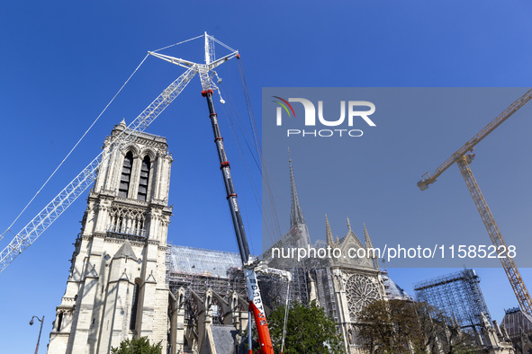 An exterior view of Notre Dame and construction cranes while the reconstruction process takes place in Paris, France, on September 15, 2024....