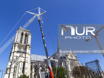 An exterior view of Notre Dame and construction cranes while the reconstruction process takes place in Paris, France, on September 15, 2024....