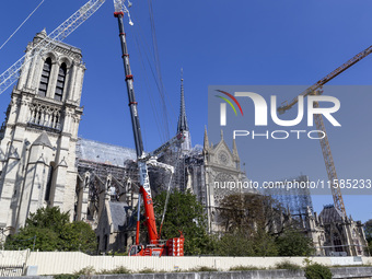 An exterior view of Notre Dame and construction cranes while the reconstruction process takes place in Paris, France, on September 15, 2024....