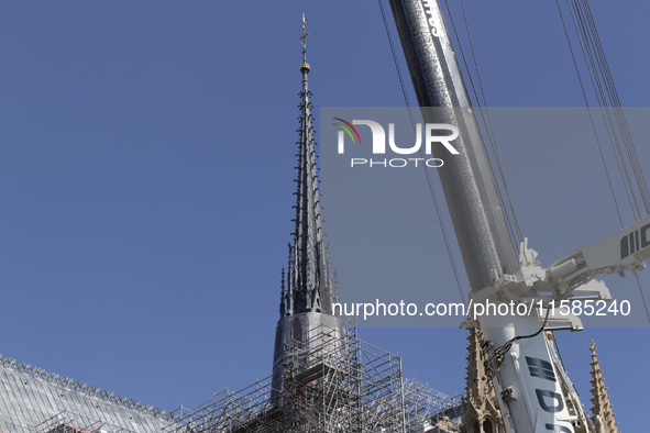 An exterior view of Notre Dame and construction cranes while the reconstruction process takes place in Paris, France, on September 15, 2024....