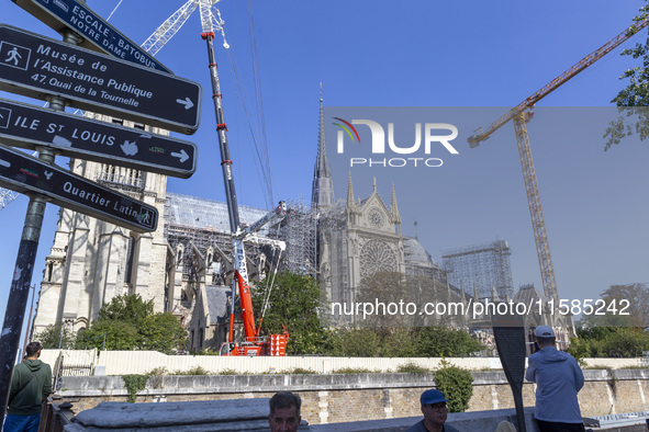 An exterior view of Notre Dame and construction cranes while the reconstruction process takes place in Paris, France, on September 15, 2024....