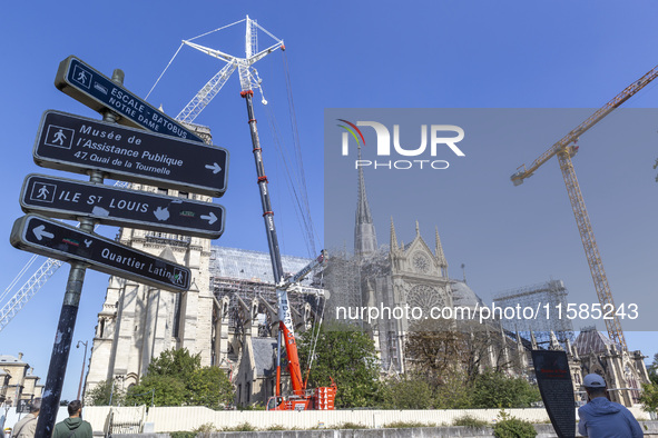 An exterior view of Notre Dame and construction cranes while the reconstruction process takes place in Paris, France, on September 15, 2024....