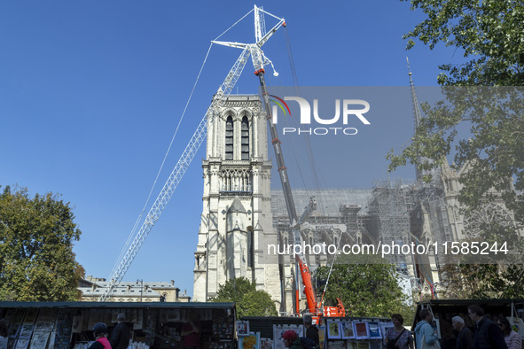 An exterior view of Notre Dame and construction cranes while the reconstruction process takes place in Paris, France, on September 15, 2024....