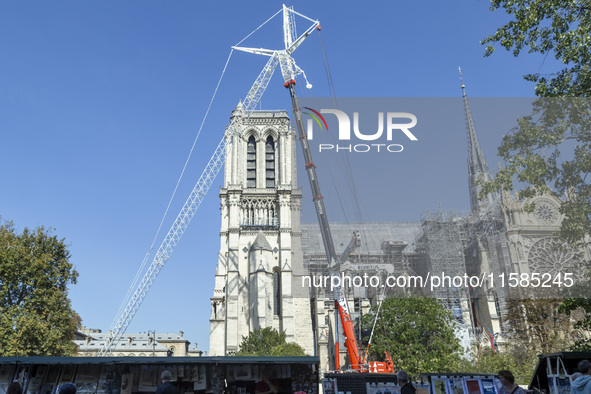 An exterior view of Notre Dame and construction cranes while the reconstruction process takes place in Paris, France, on September 15, 2024....