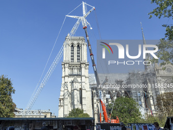 An exterior view of Notre Dame and construction cranes while the reconstruction process takes place in Paris, France, on September 15, 2024....