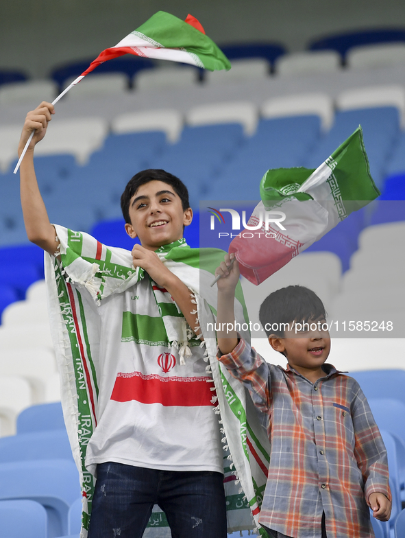 Tractor SC supporters cheer for their team before the AFC Champions League Two Group A football match between Qatar's Al Wakrah SC and Iran'...