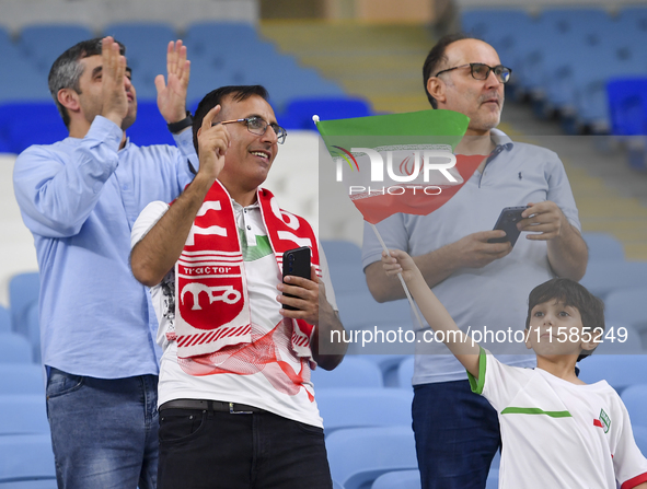 Tractor SC supporters cheer for their team before the AFC Champions League Two Group A football match between Qatar's Al Wakrah SC and Iran'...