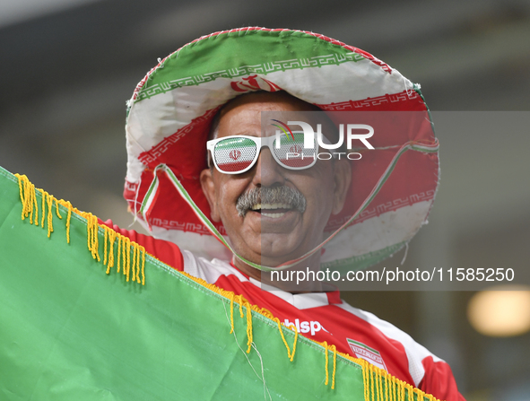 A Tractor SC supporter cheers for their team before the AFC Champions League Two Group A football match between Qatar's Al Wakrah SC and Ira...