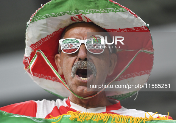 A Tractor SC supporter cheers for their team before the AFC Champions League Two Group A football match between Qatar's Al Wakrah SC and Ira...