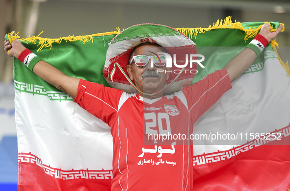 A Tractor SC supporter cheers for their team before the AFC Champions League Two Group A football match between Qatar's Al Wakrah SC and Ira...