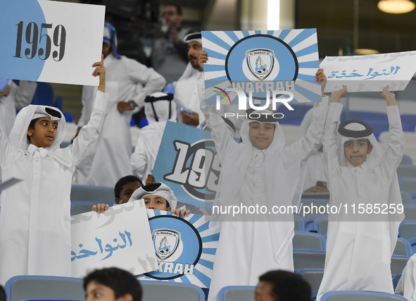 Al Wakrah SC supporters cheer for their team before the AFC Champions League Two Group A football match between Qatar's Al Wakrah SC and Ira...