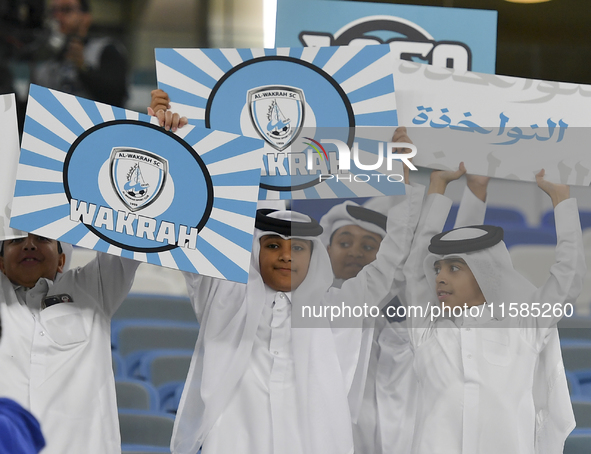 Al Wakrah SC supporters cheer for their team before the AFC Champions League Two Group A football match between Qatar's Al Wakrah SC and Ira...