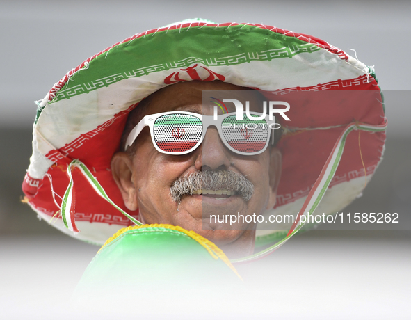 A Tractor SC supporter cheers for their team before the AFC Champions League Two Group A football match between Qatar's Al Wakrah SC and Ira...