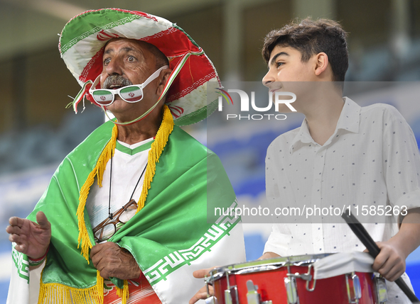 Tractor SC supporters cheer for their team before the AFC Champions League Two Group A football match between Qatar's Al Wakrah SC and Iran'...