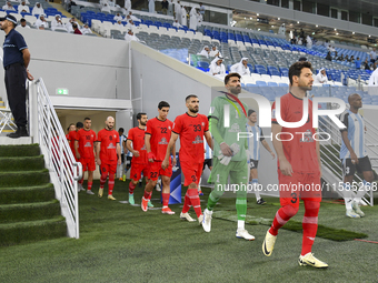 Tractor SC and Al Wakrah players walk onto the pitch before the AFC Champions League Two Group A football match between Qatar's Al Wakrah SC...