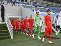 Tractor SC and Al Wakrah players walk onto the pitch before the AFC Champions League Two Group A football match between Qatar's Al Wakrah SC...